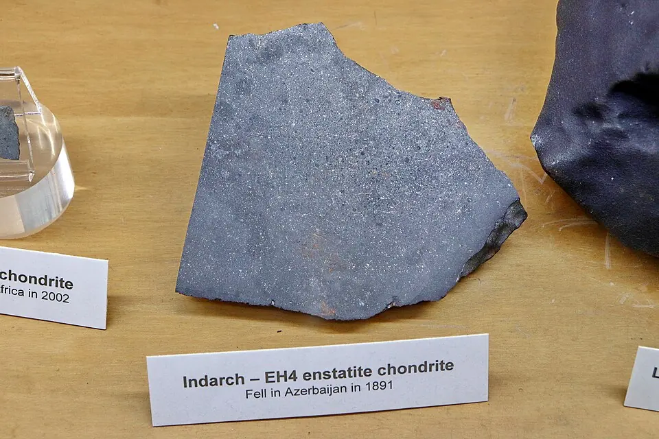 A piece of the Indarch meteorite, which fell in Azerbaijan in 1891. It is an enstatite chondrite, one of the meteorites whose composition is closest to that of the Earth. UCLA Meteorite Gallery, Los Angeles.