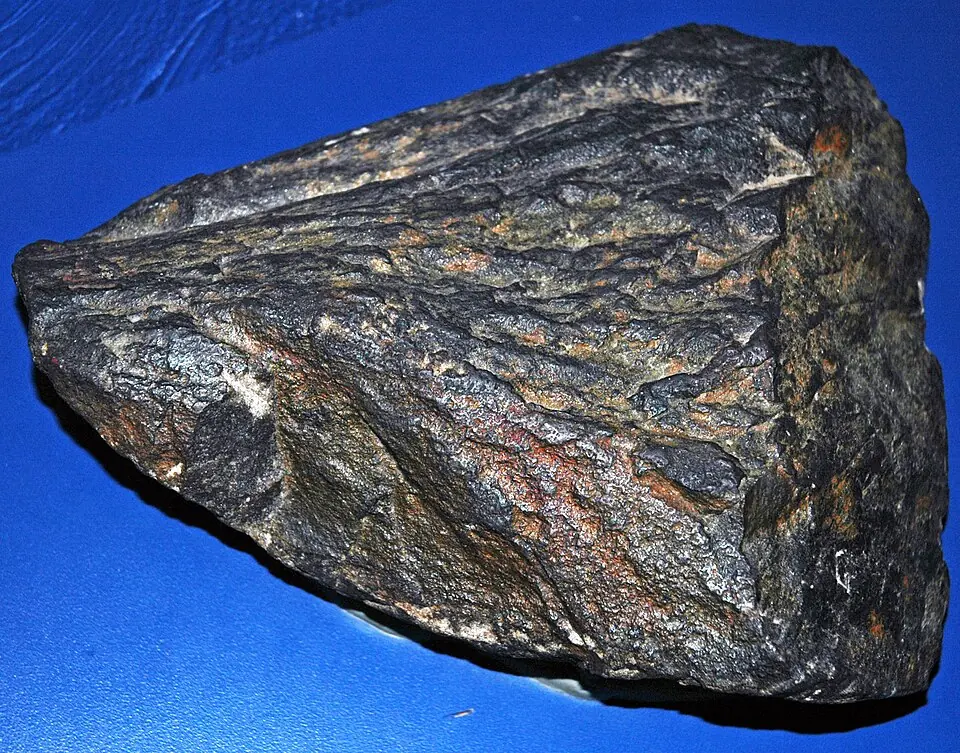 A shatter cone from the Sudbury impact structure, Ontario, 1.85 billion years old. The shock wave of an impact imprints these grooved cones in rock. Cleveland Museum of Natural History.