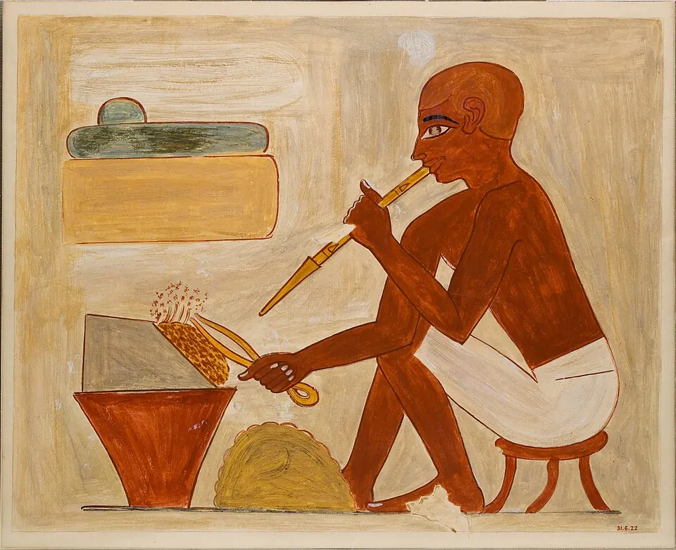 Working metal with fire: a metalworker fans his hearth with a blowpipe. The scene is Egyptian and more than three thousand years later than the copper smelting at Belovode. The picture is a facsimile (an exact copy) by Nina M. Davies of a painting in the tomb of Rekhmire. Metropolitan Museum of Art, New York.