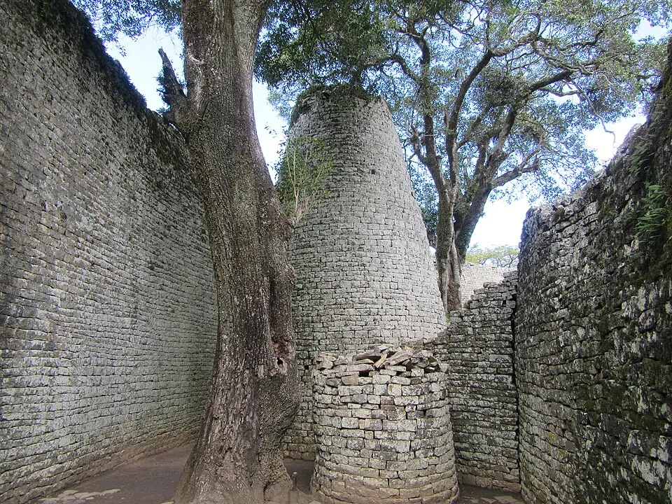 The conical tower of Great Zimbabwe, between the stone walls of the enclosure.